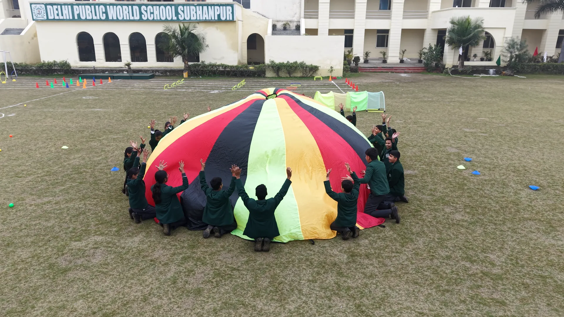 Primary students playing the parachute game on the school ground